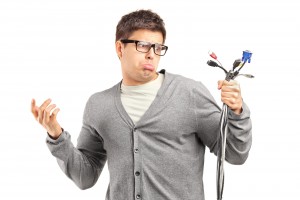 Confused-male-holding cables